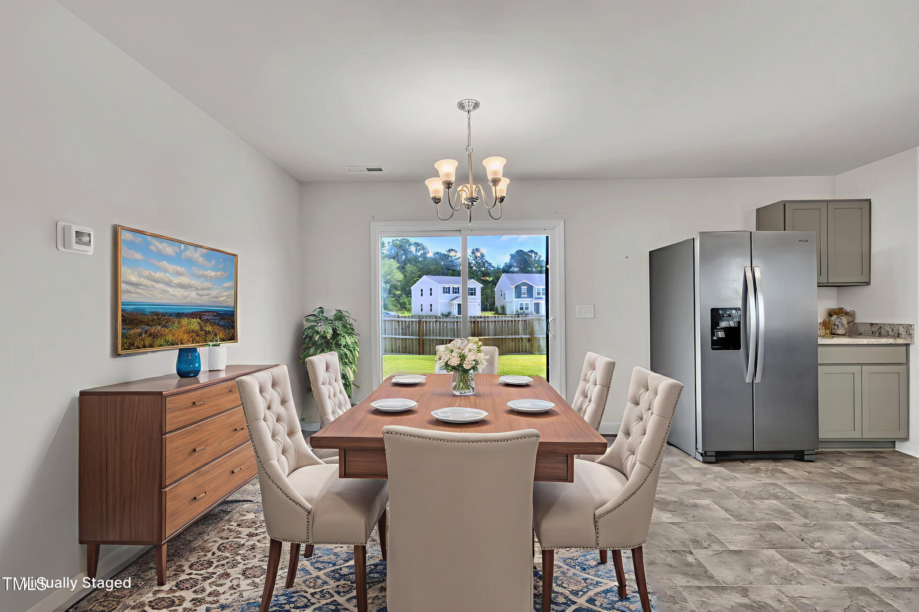 146 Maple Tree Lane Clayton, NC 27527 - Photo 22 of 50 a view of a dining room with furniture a livingroom and chandelier
