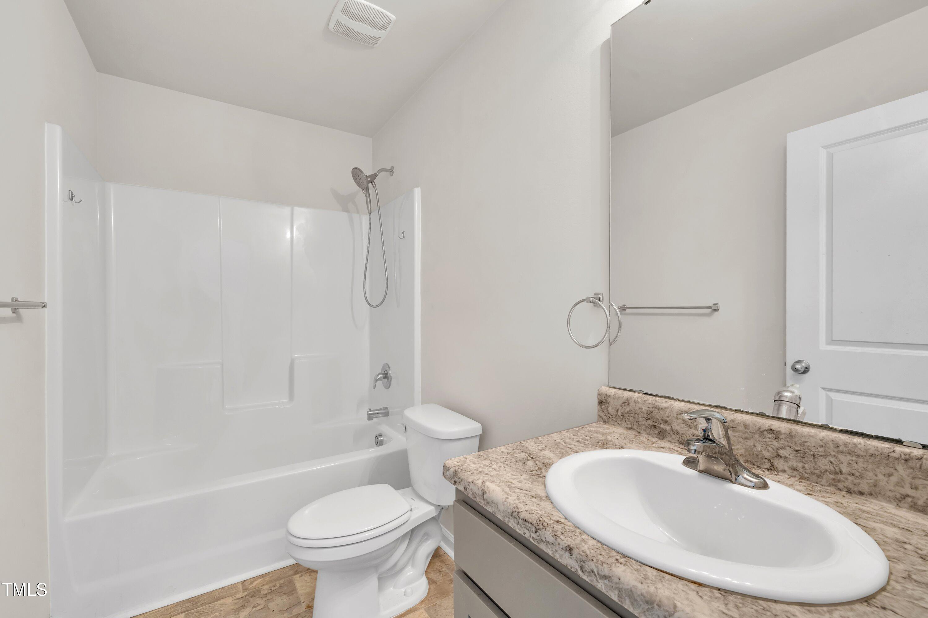 146 Maple Tree Lane Clayton, NC 27527 - Photo 23 of 50 a bathroom with a granite countertop sink a toilet and a mirror