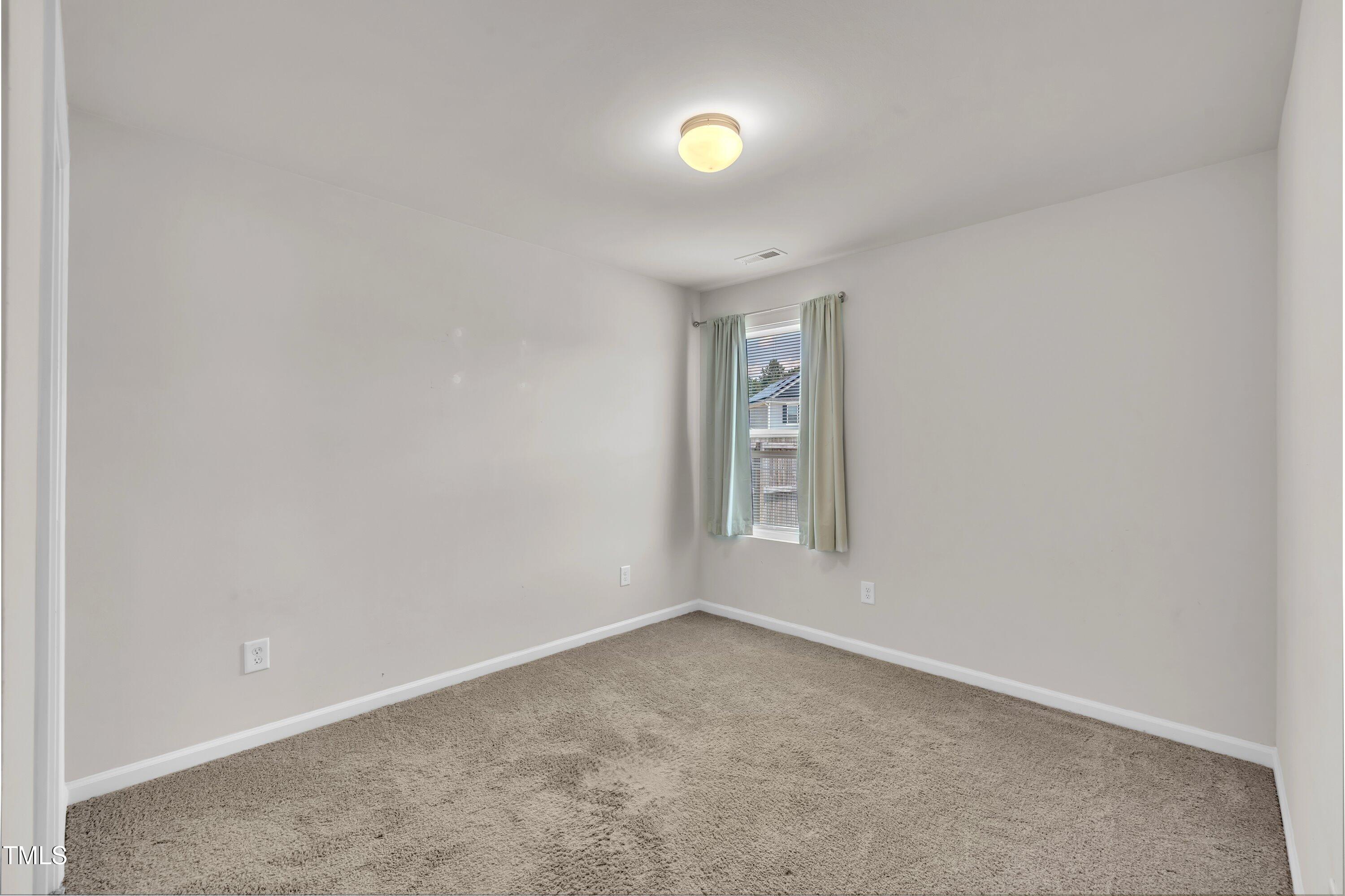 146 Maple Tree Lane Clayton, NC 27527 - Photo 24 of 50 an empty room with windows