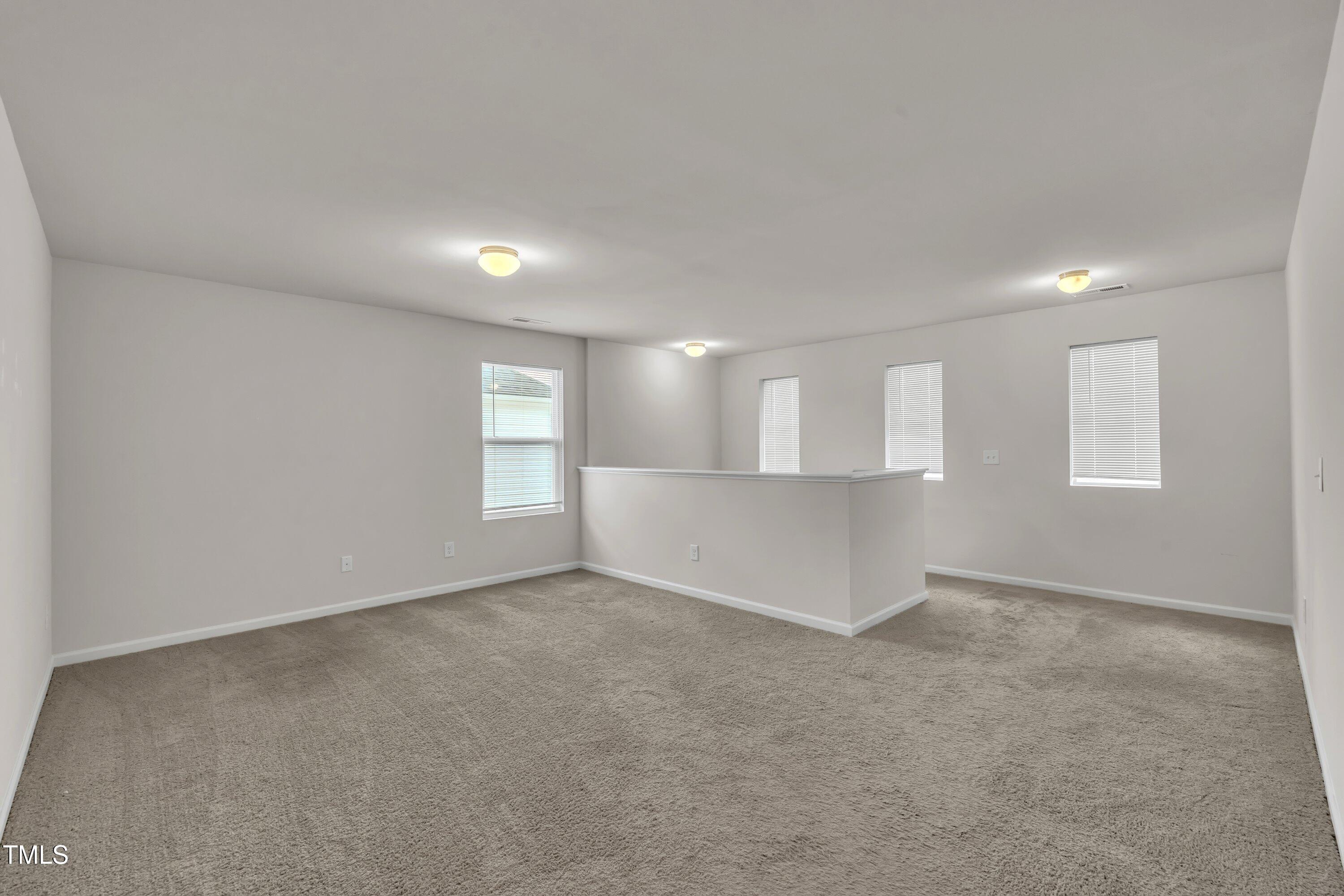 146 Maple Tree Lane Clayton, NC 27527 - Photo 27 of 50 an empty room with windows and entrance