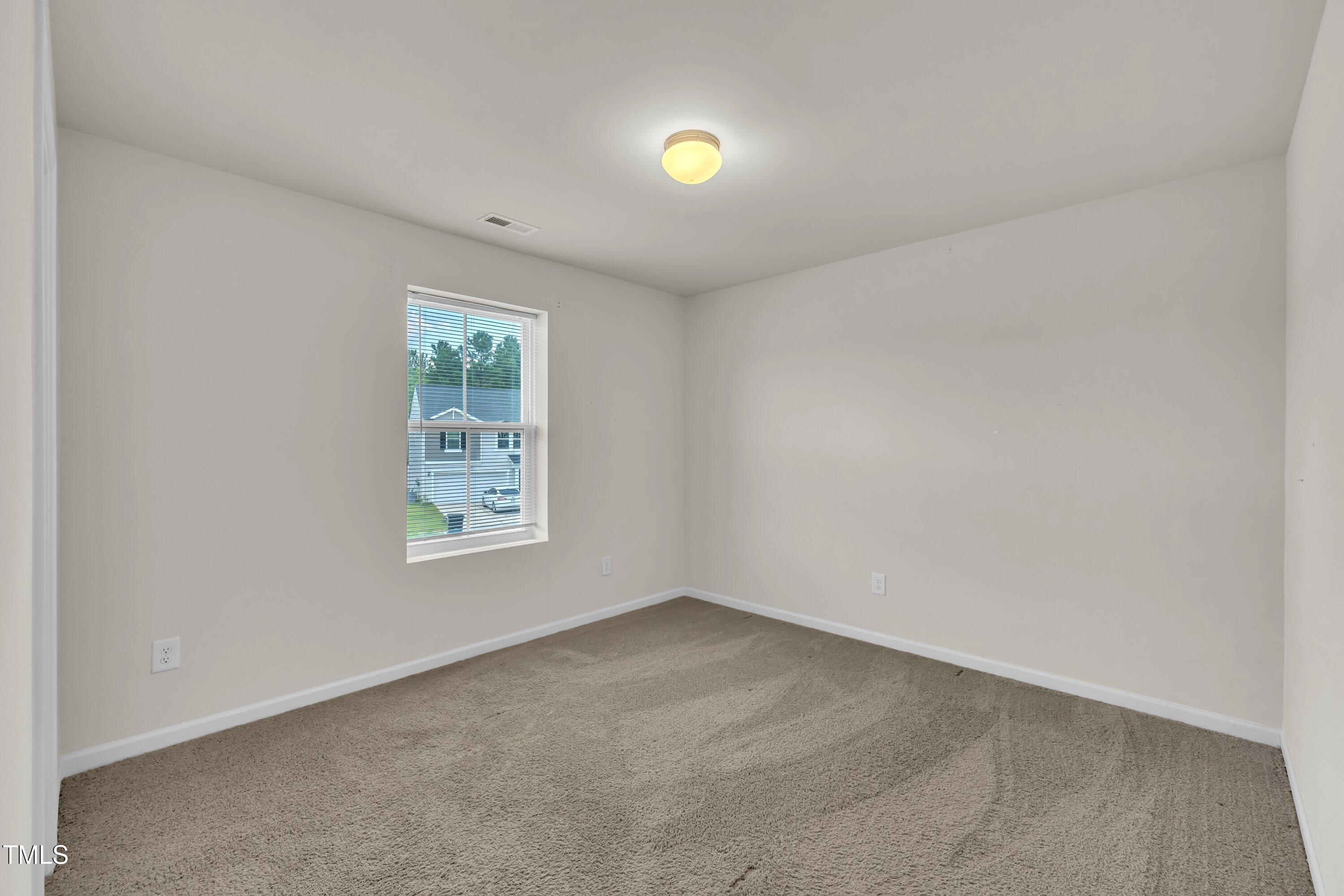 146 Maple Tree Lane Clayton, NC 27527 - Photo 29 of 50 an empty room with windows and mirror