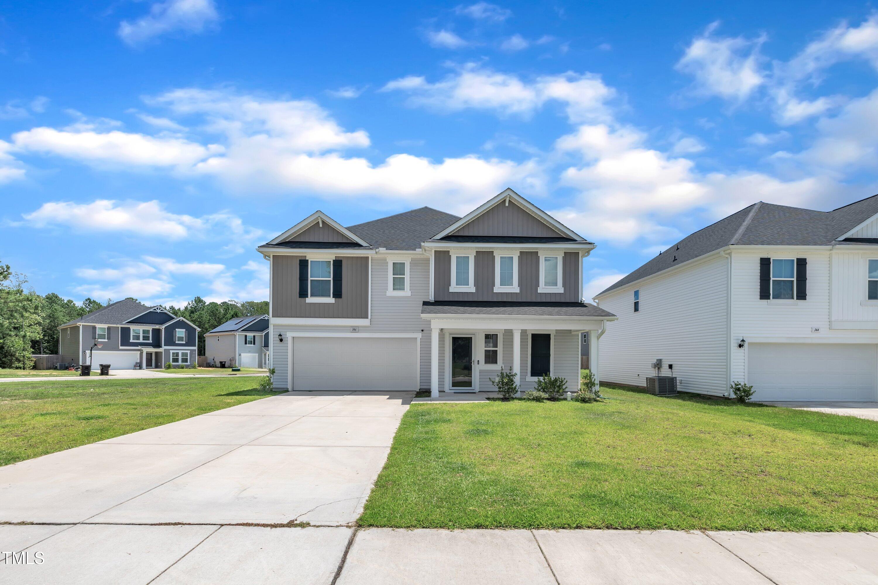 146 Maple Tree Lane Clayton, NC 27527 - Photo 2 of 50 a front view of a house with a garden