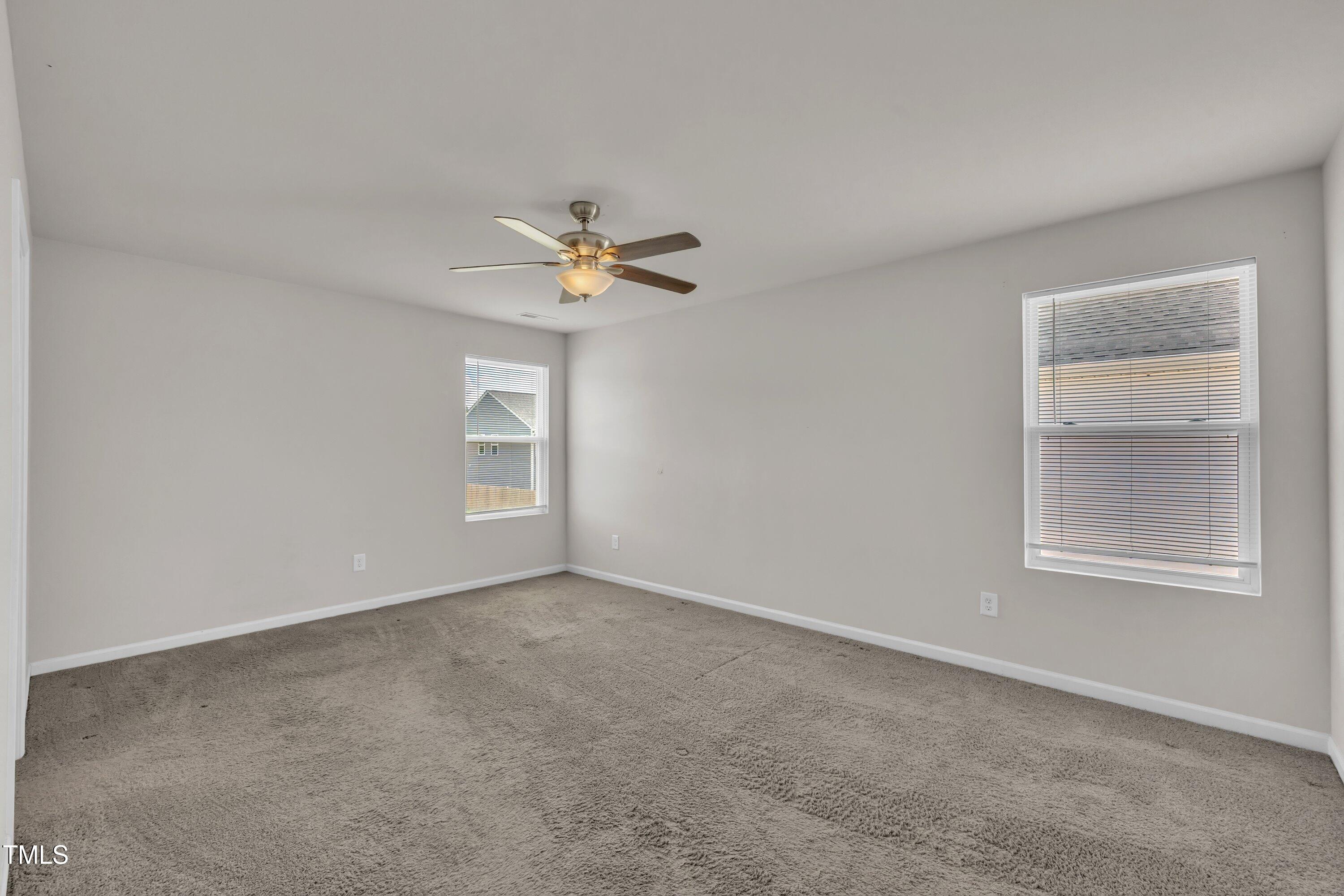146 Maple Tree Lane Clayton, NC 27527 - Photo 33 of 50 an empty room with windows and fan