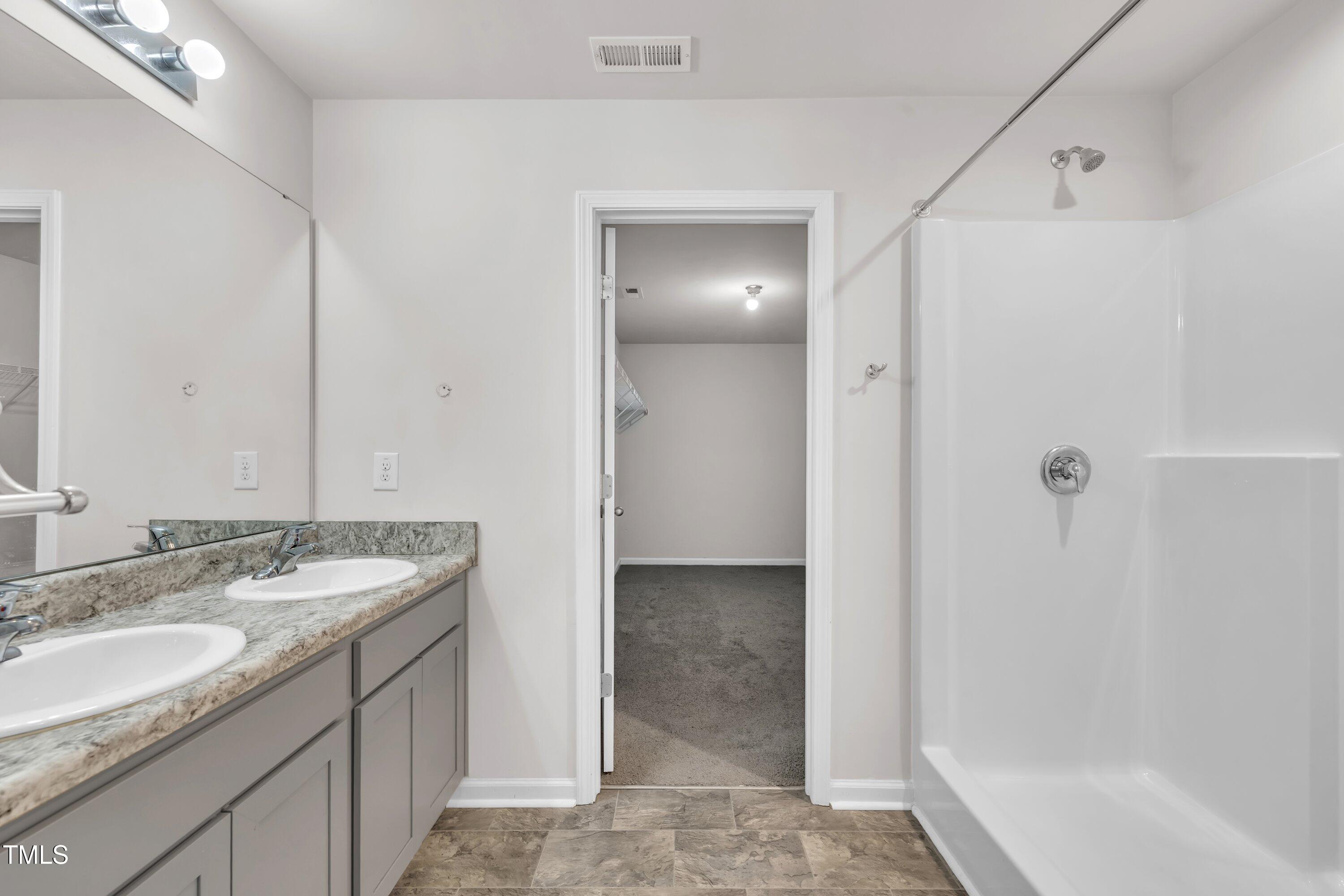 146 Maple Tree Lane Clayton, NC 27527 - Photo 38 of 50 a bathroom with a granite countertop sink and a mirror