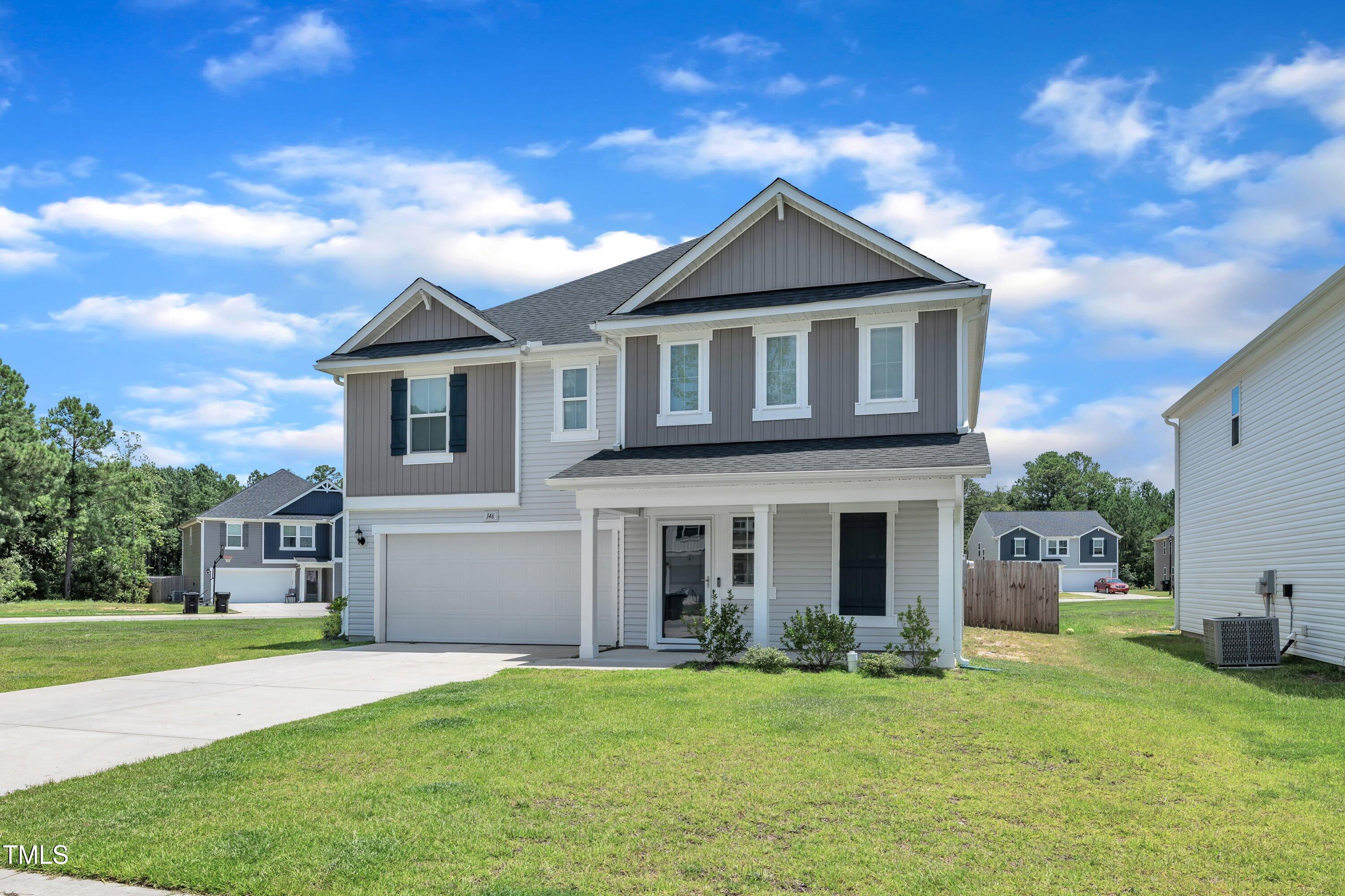 146 Maple Tree Lane Clayton, NC 27527 - Photo 3 of 50 a front view of a house with a yard