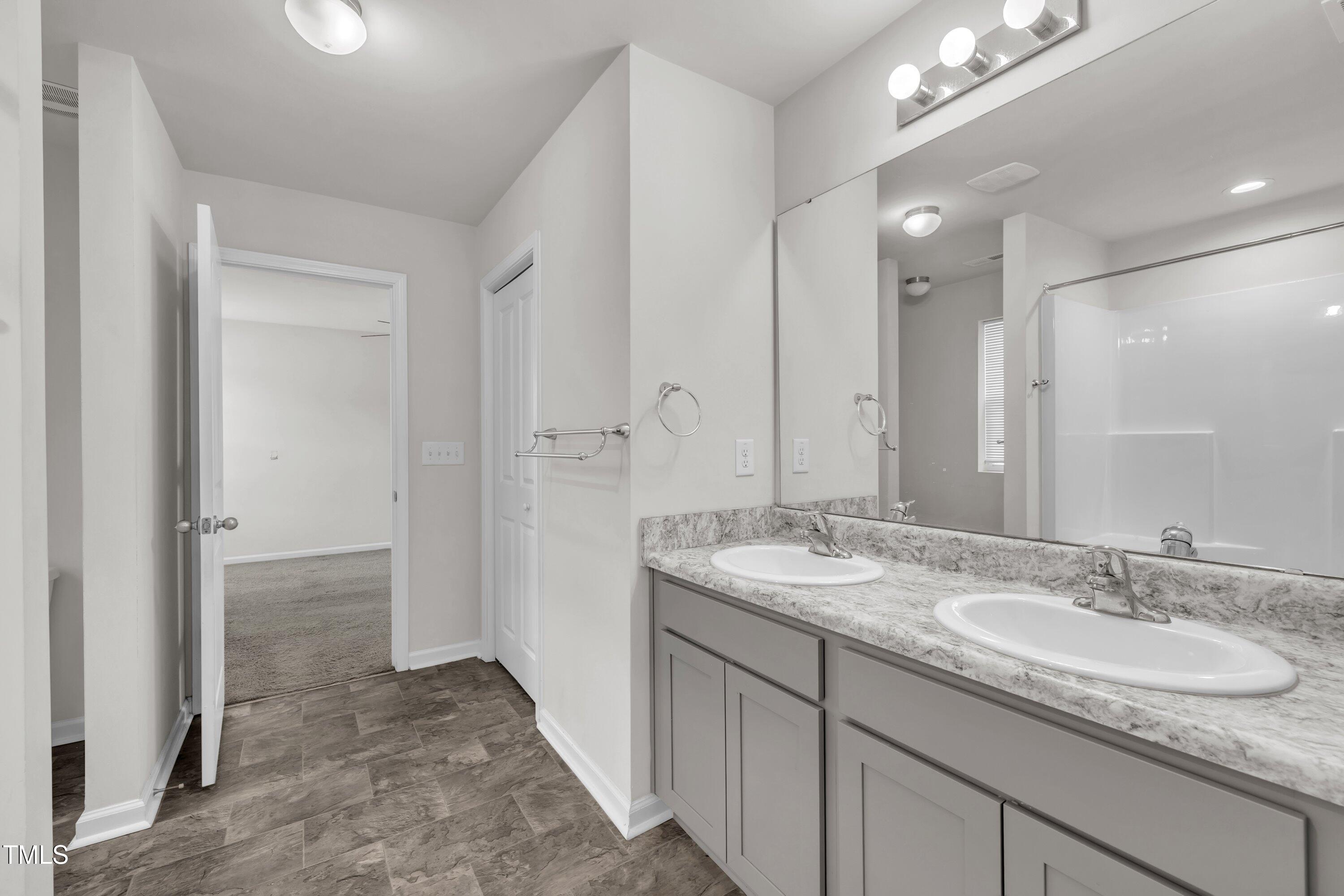 146 Maple Tree Lane Clayton, NC 27527 - Photo 40 of 50 a bathroom with a granite countertop sink and a mirror