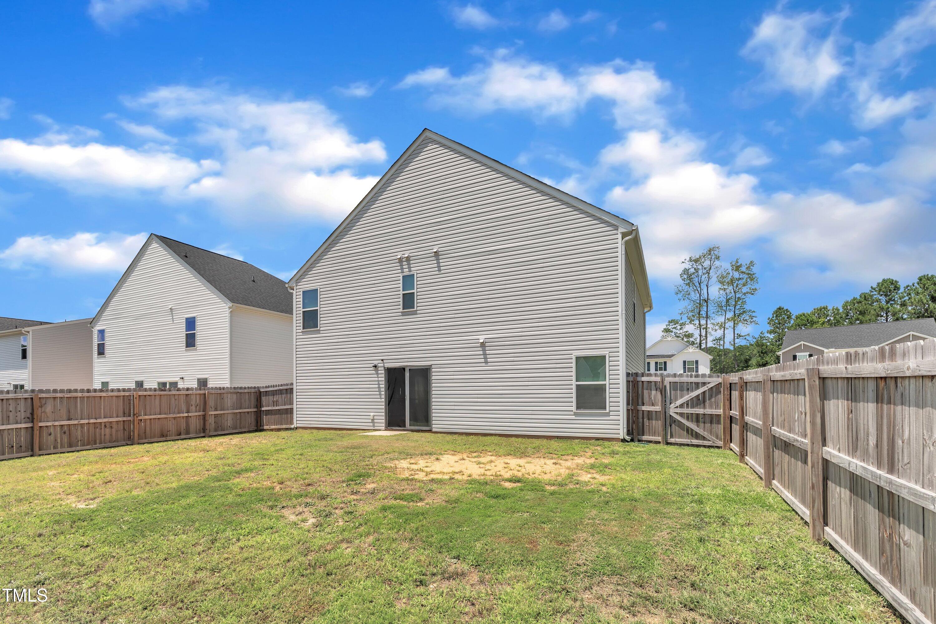 146 Maple Tree Lane Clayton, NC 27527 - Photo 46 of 50 a view of a house with wooden fence and a big yard