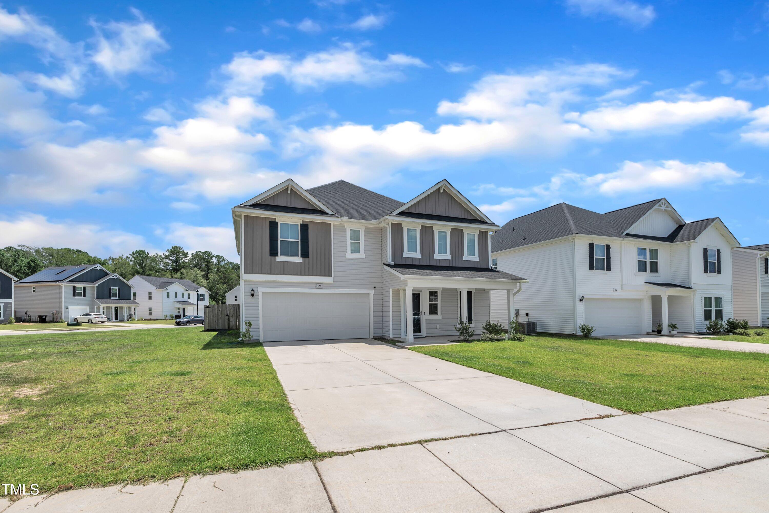 146 Maple Tree Lane Clayton, NC 27527 - Photo 4 of 50 front view of a house with a yard