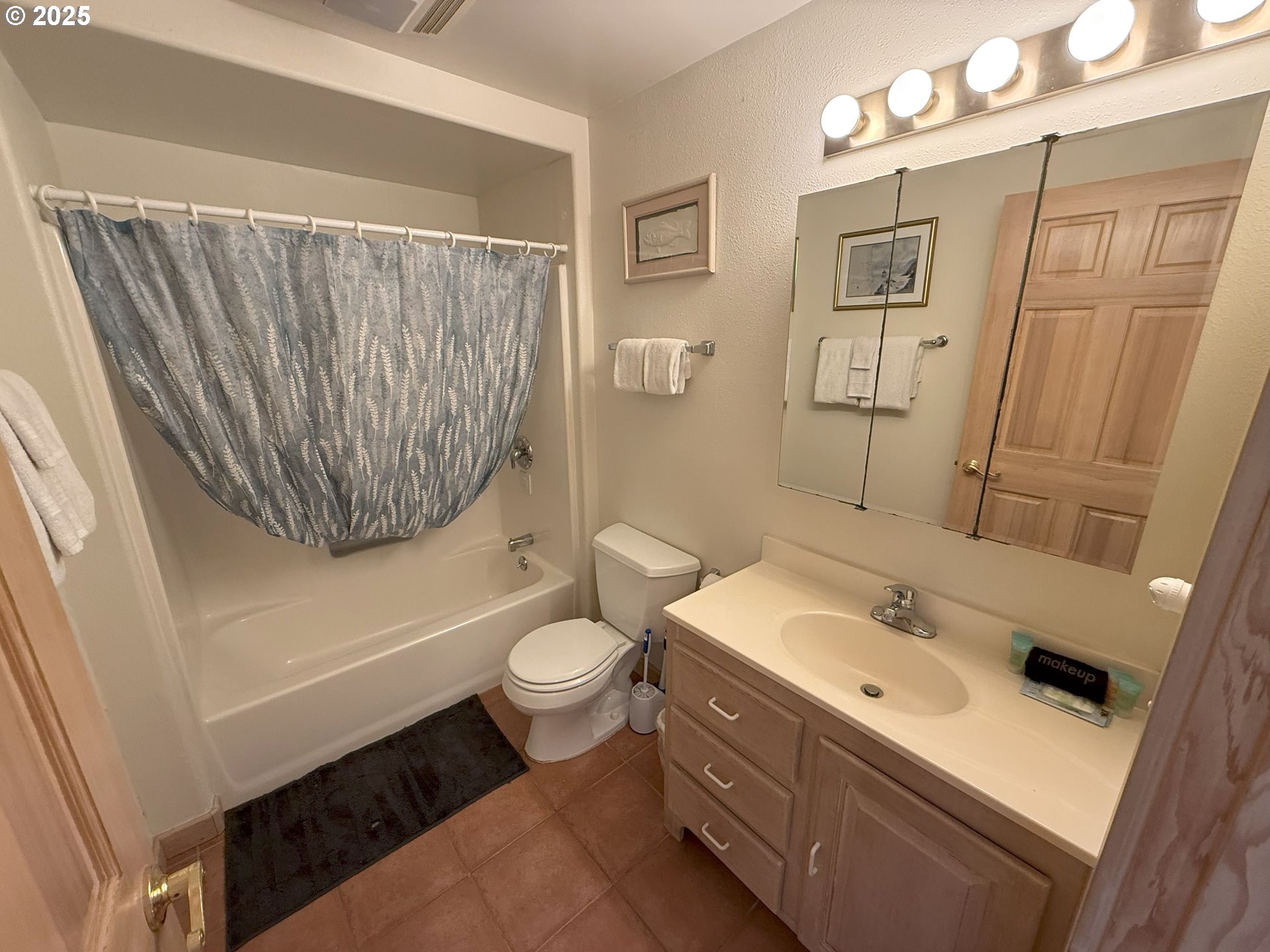 4529 Lookout Street Florence, OR 97439 - Photo 16 of 46 a bathroom with a sink toilet mirror vanity and shower