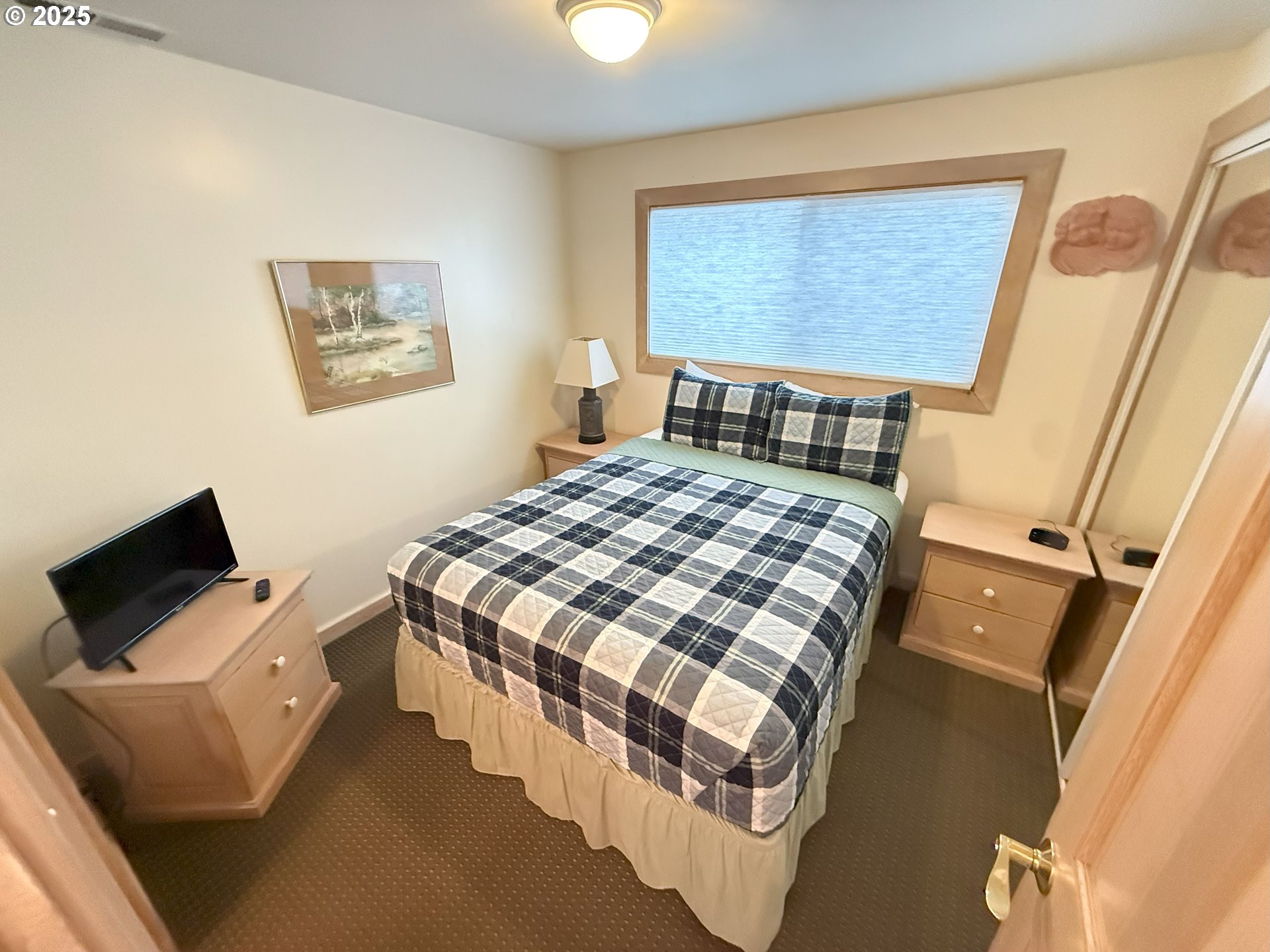 4529 Lookout Street Florence, OR 97439 - Photo 21 of 46 a bedroom with a bed and wooden floor