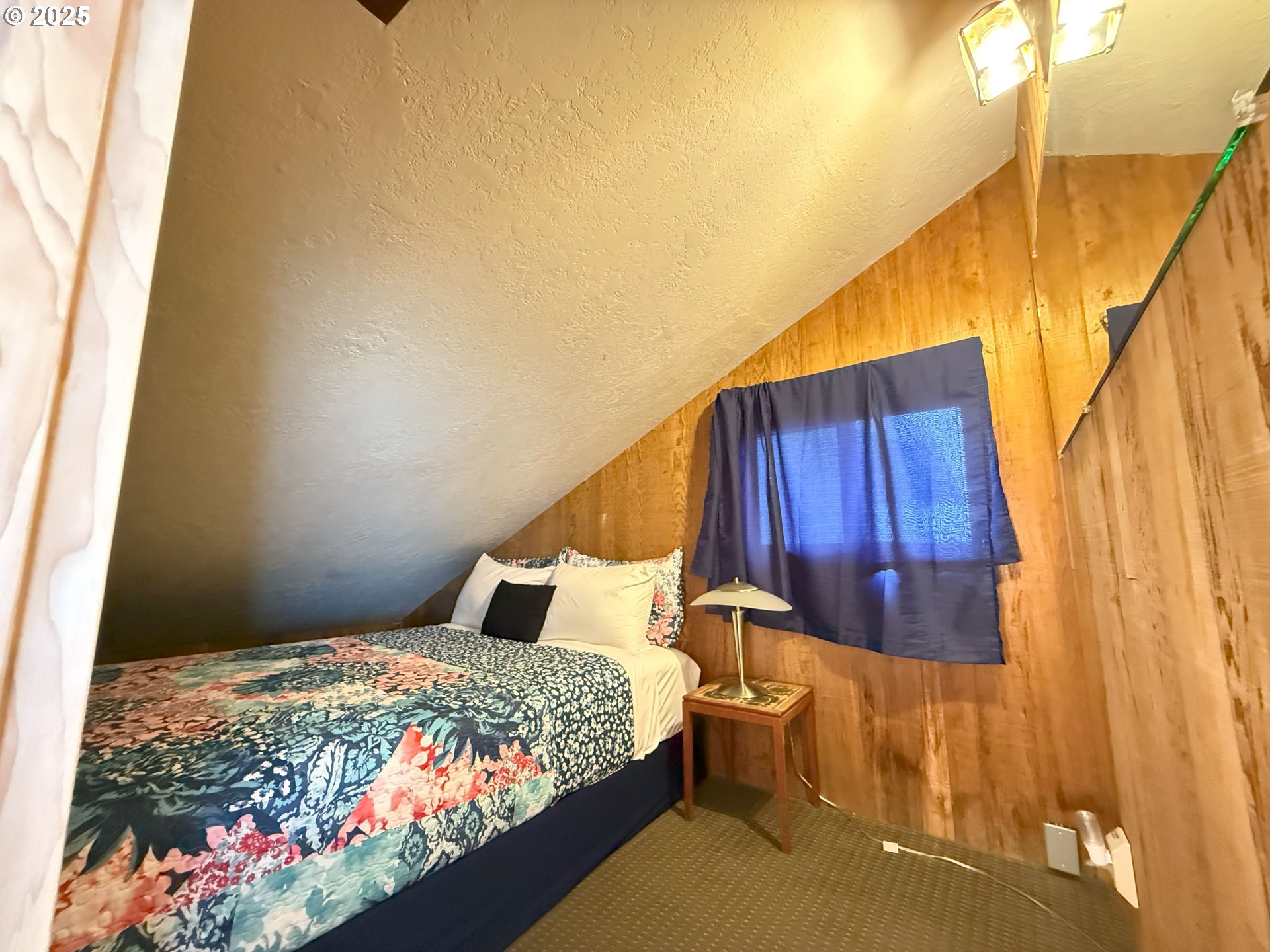 4529 Lookout Street Florence, OR 97439 - Photo 25 of 46 a bedroom with a bed and a painting on the wall