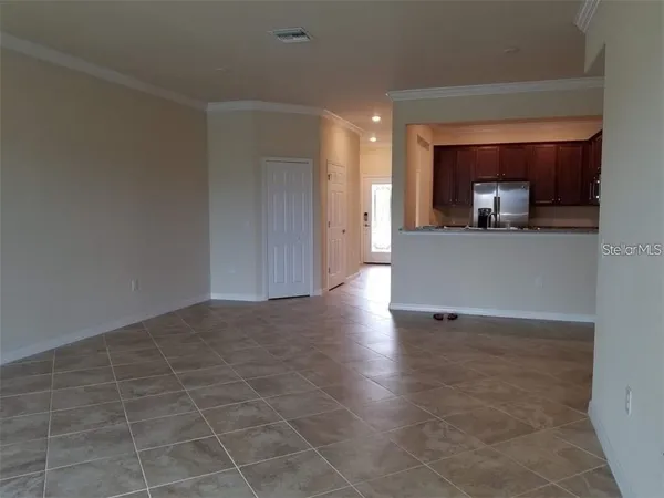 a view of a room with wooden floor and a window