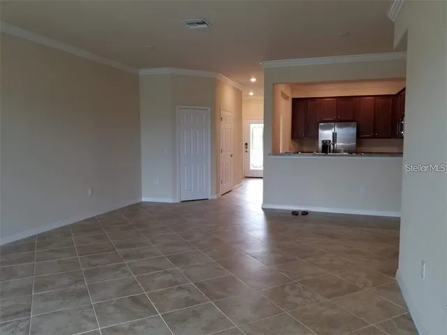 a view of a room with wooden floor and a window