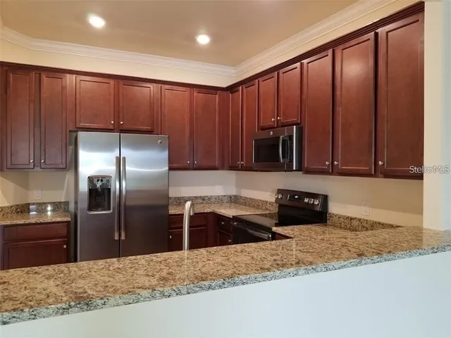 a kitchen with granite countertop stainless steel appliances and granite counter tops