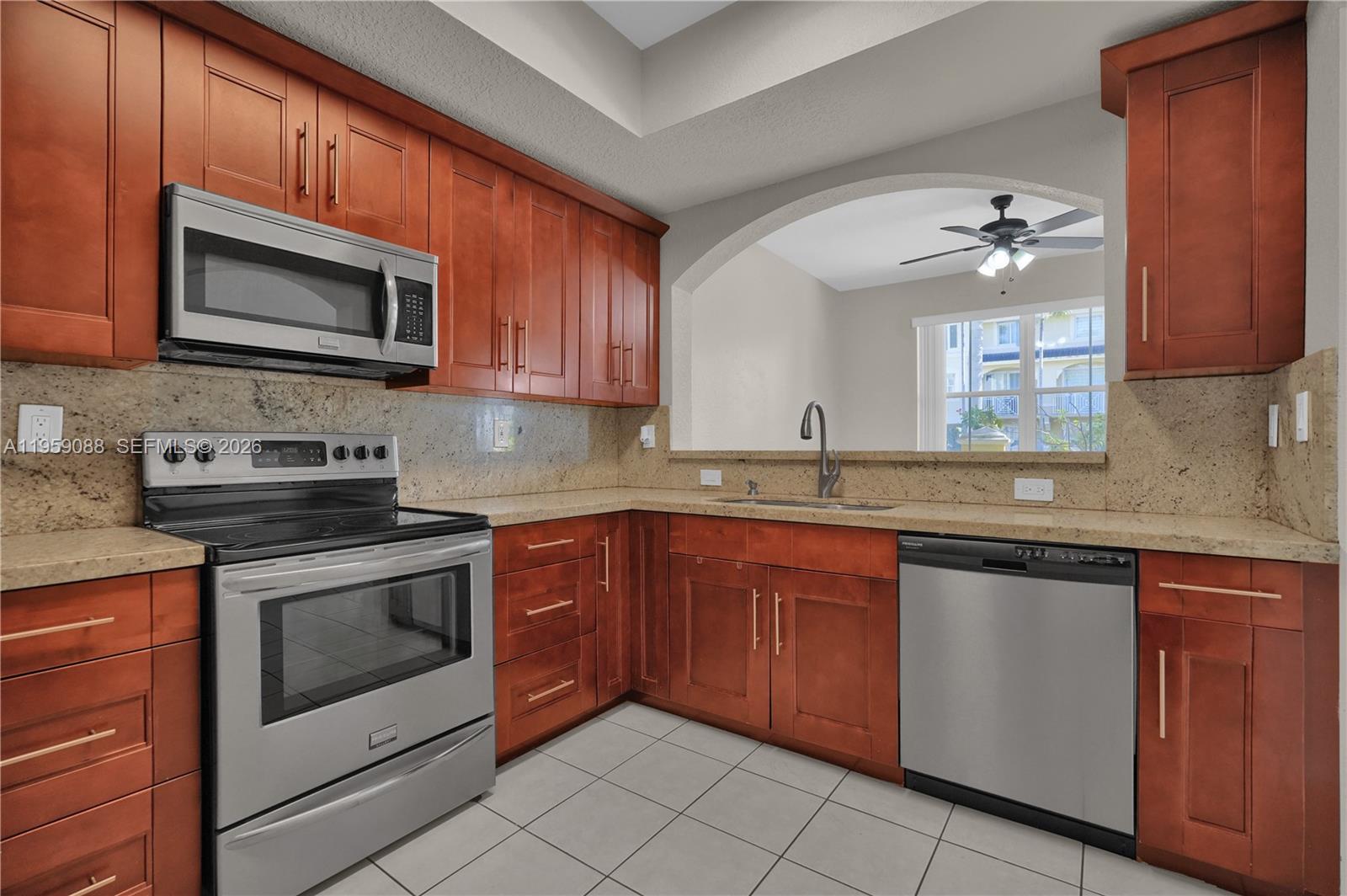 8964 West Flagler Street, Unit 109 Miami, FL 33174 - Photo 13 of 39 a kitchen with stainless steel appliances granite countertop a stove microwave and sink