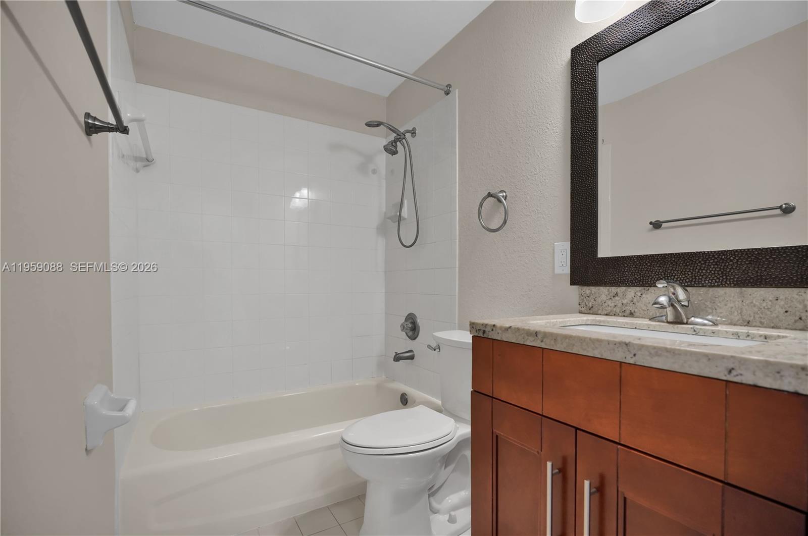8964 West Flagler Street, Unit 109 Miami, FL 33174 - Photo 22 of 39 a bathroom with a sink a toilet and shower