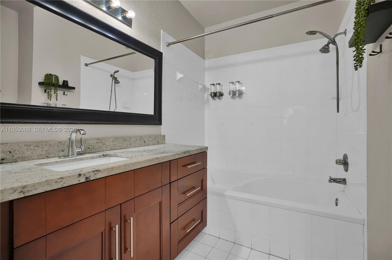 8964 West Flagler Street, Unit 109 Miami, FL 33174 - Photo 25 of 39 a bathroom with a granite countertop sink mirror and a