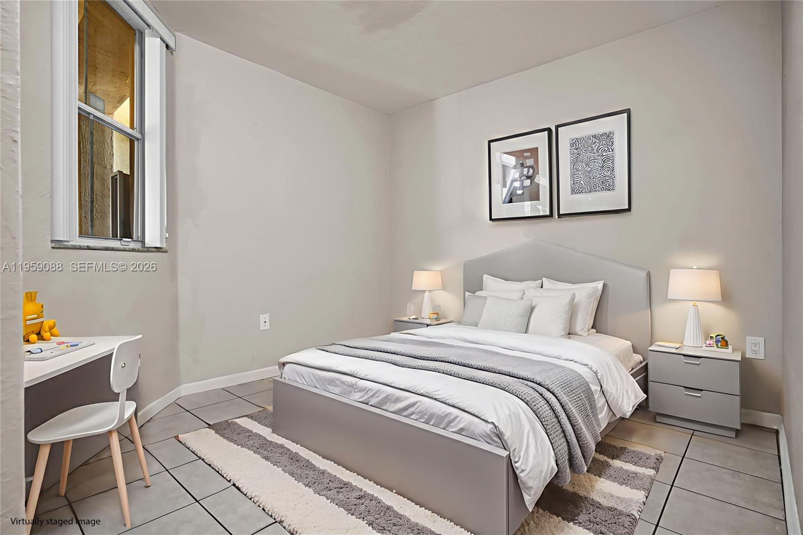 8964 West Flagler Street, Unit 109 Miami, FL 33174 - Photo 26 of 39 a bedroom with a bed and a lamp on dresser