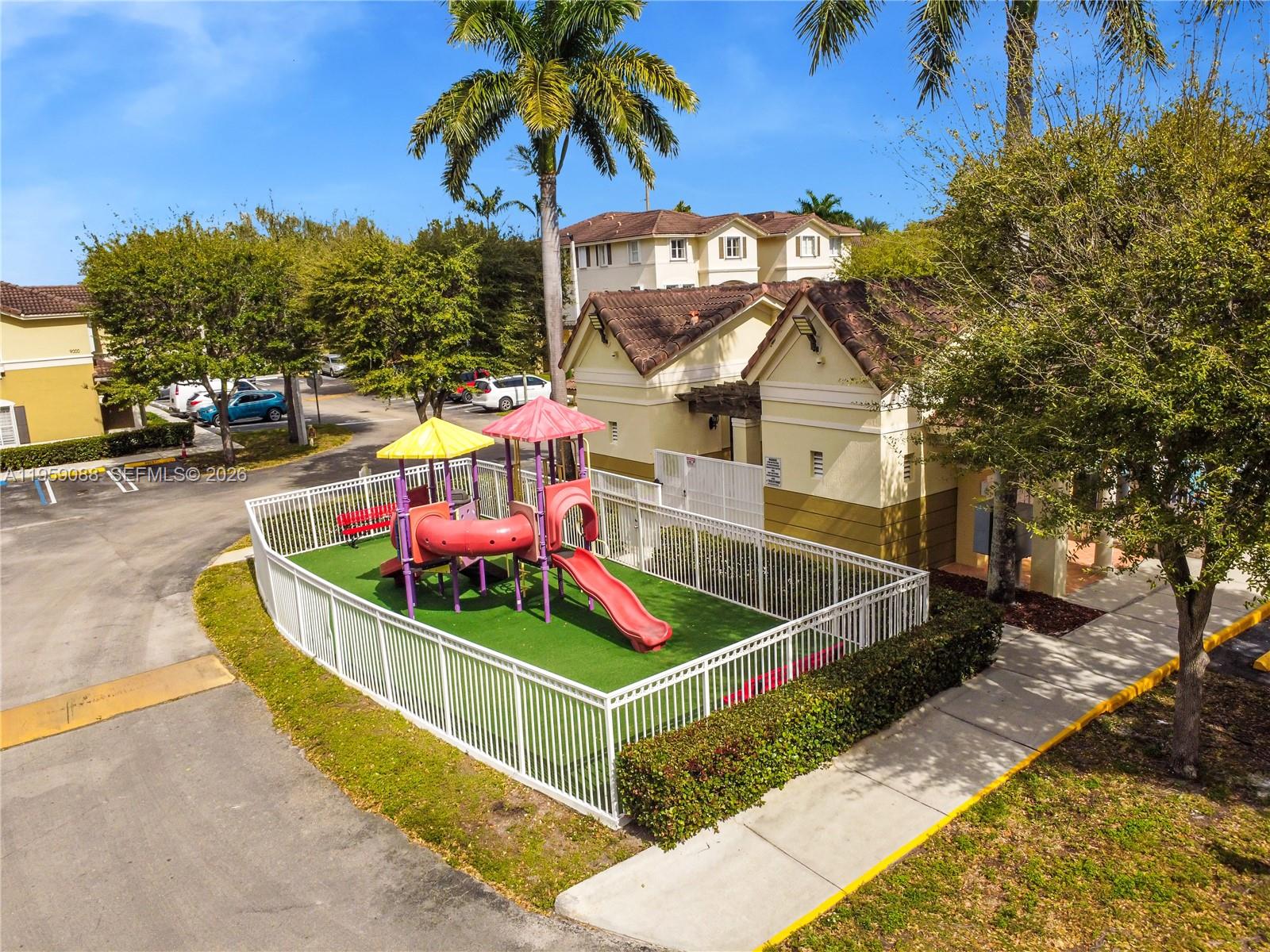 8964 West Flagler Street, Unit 109 Miami, FL 33174 - Photo 33 of 39 a front view of a house with a yard