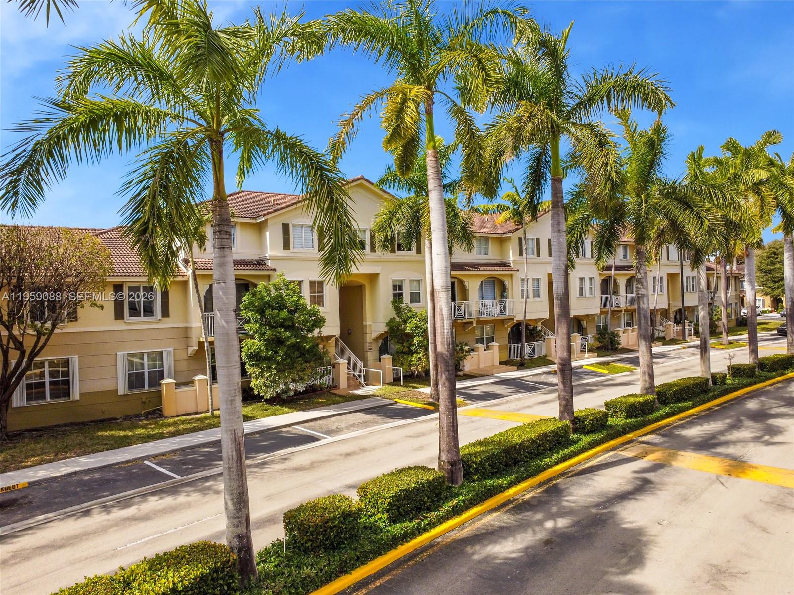 8964 West Flagler Street, Unit 109 Miami, FL 33174 - Photo 37 of 39 a view of a palm trees in front of a building