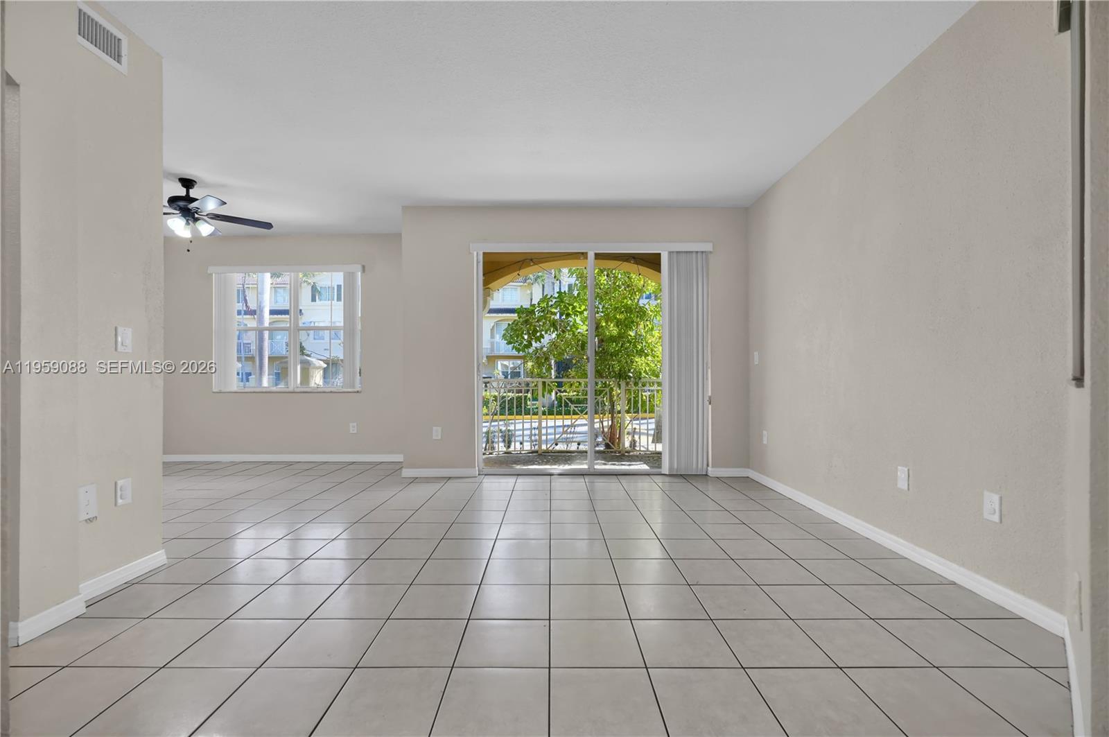 8964 West Flagler Street, Unit 109 Miami, FL 33174 - Photo 8 of 39 a view of an empty room with a window