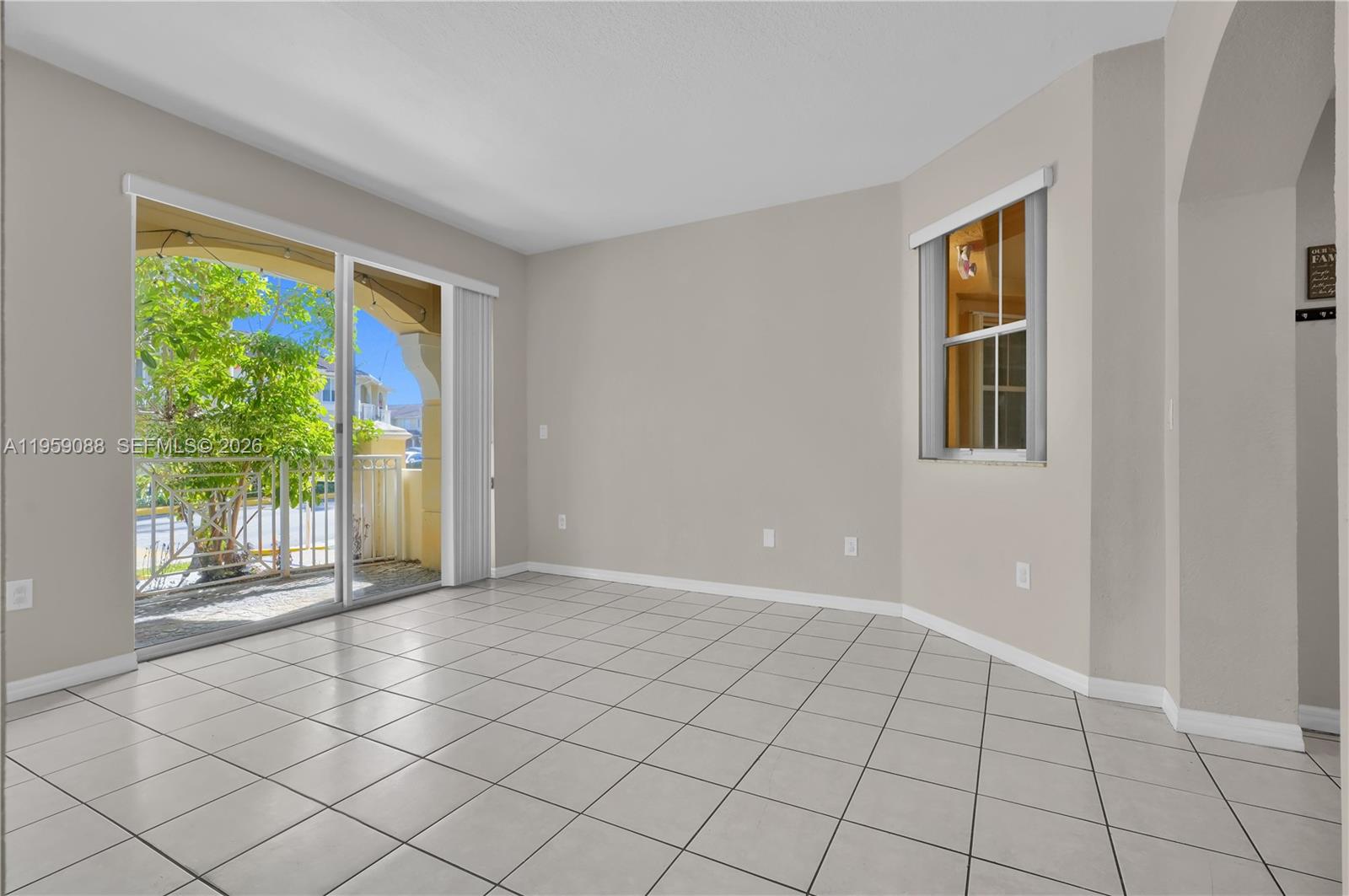 8964 West Flagler Street, Unit 109 Miami, FL 33174 - Photo 9 of 39 a view of an empty room with a window
