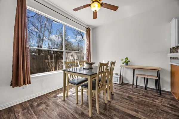 a view of a dining room with furniture and wooden floor