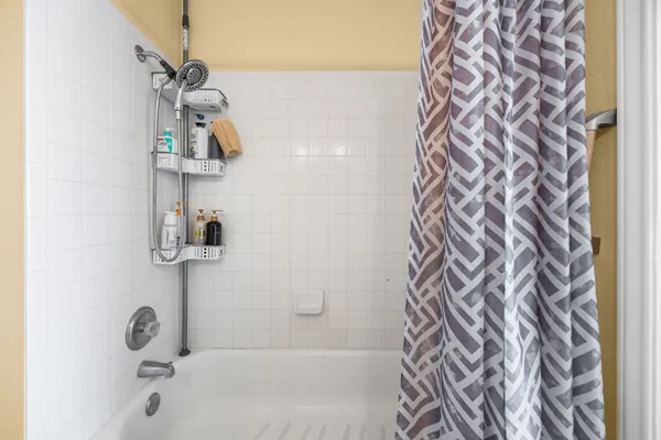 a bathroom with a shower and a shower curtain