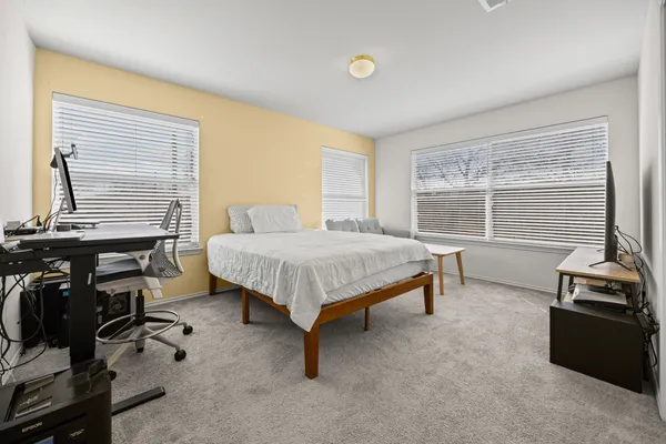 a bedroom with furniture and a window