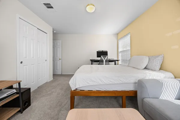 a bedroom with a bed and a chair