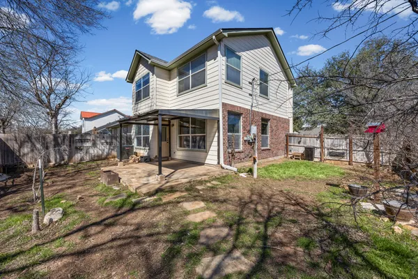 a view of a house with backyard porch and sitting area