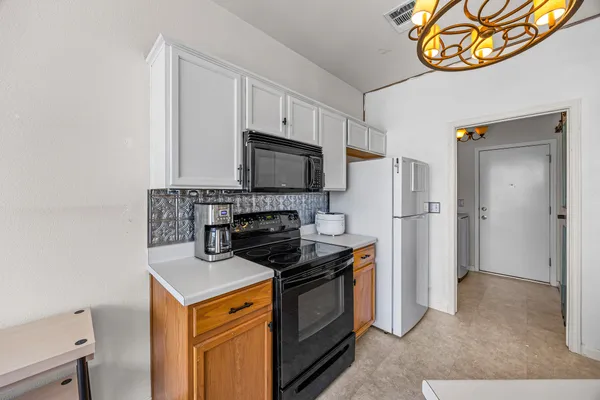 a kitchen with stainless steel appliances a stove microwave and a refrigerator