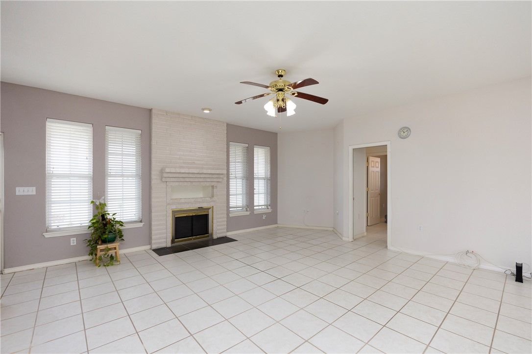 8101 Mt Zion Corpus Christi, TX 78413 - Photo 8 of 36 a view of a livingroom with a fireplace and a chandelier fan