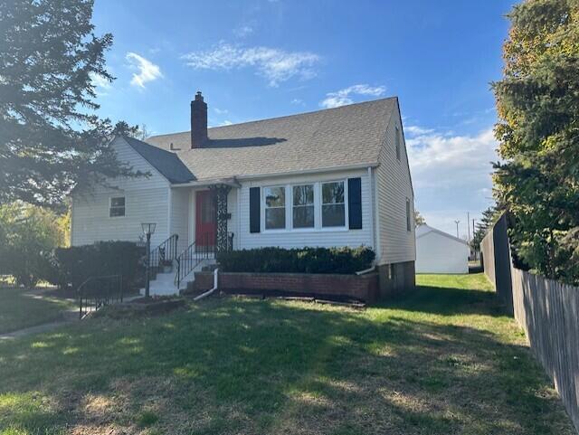 a front view of house with yard and outdoor seating
