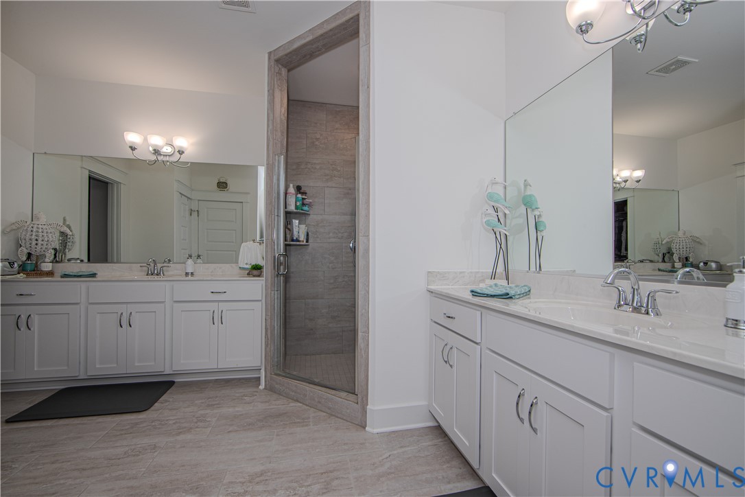 8406 Capernwray Drive Chesterfield, VA 23838 - Photo 19 of 47 a bathroom with double sink and a mirror