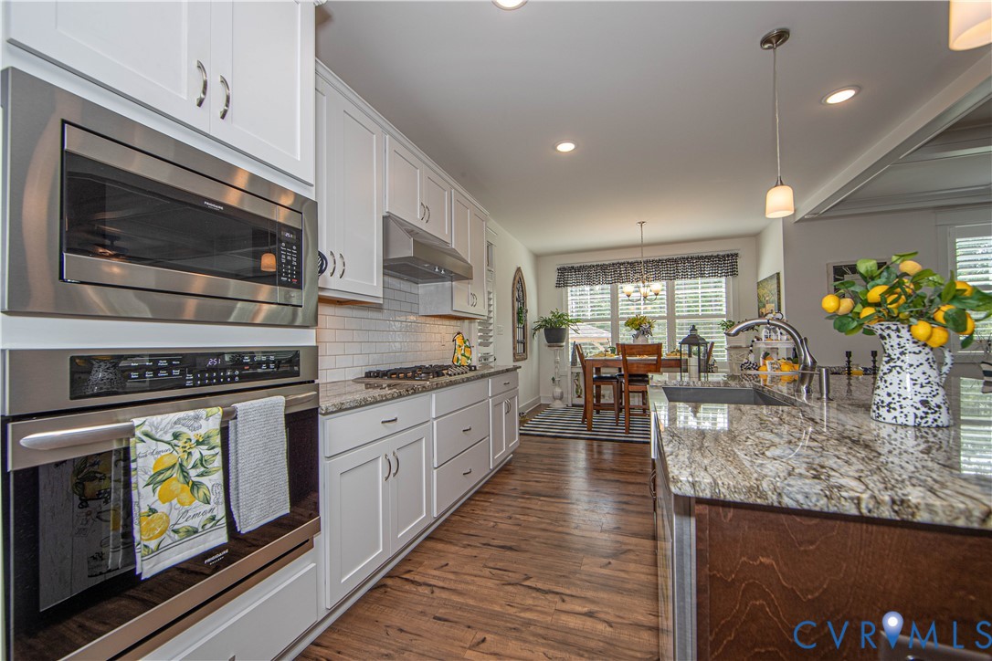 8406 Capernwray Drive Chesterfield, VA 23838 - Photo 26 of 47 a kitchen with stainless steel appliances granite countertop a stove and a microwave