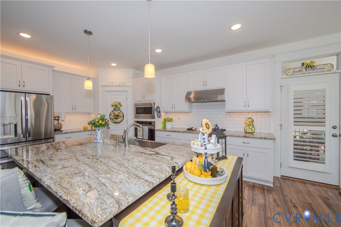 8406 Capernwray Drive Chesterfield, VA 23838 - Photo 27 of 47 a kitchen with granite countertop a table and chairs in it