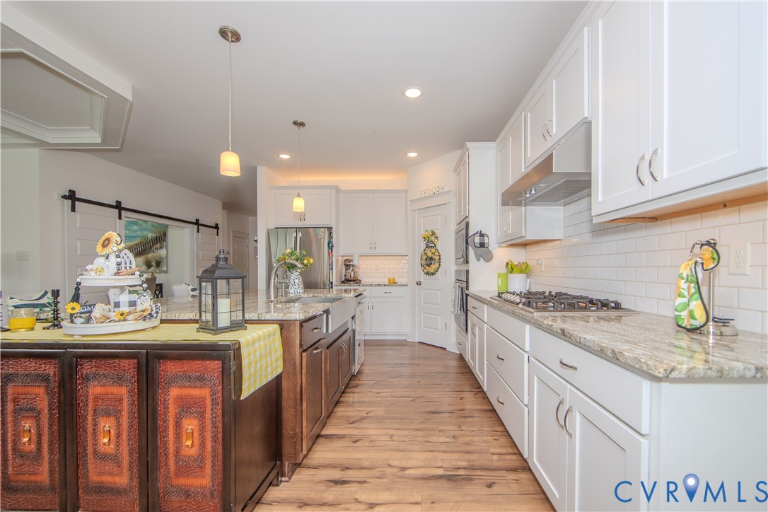 8406 Capernwray Drive Chesterfield, VA 23838 - Photo 28 of 47 a kitchen with kitchen island granite countertop lots of counter top space and stainless steel appliances