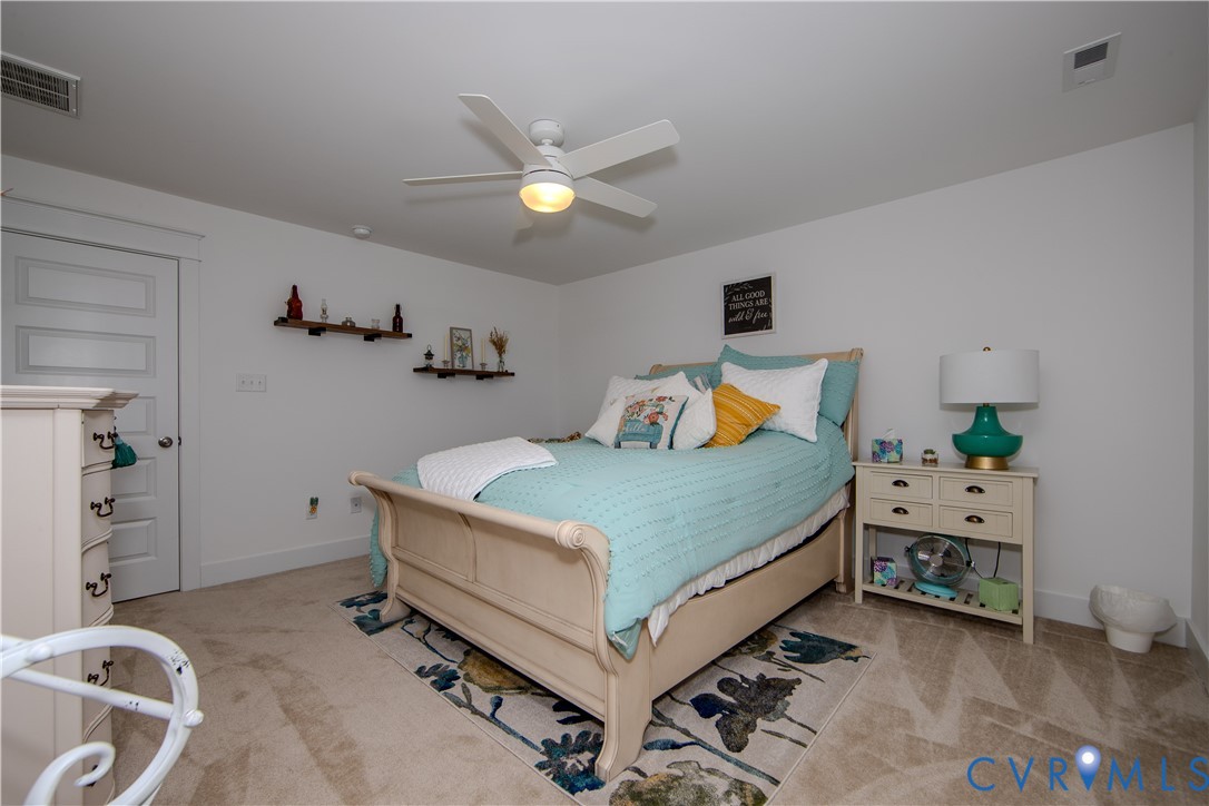 8406 Capernwray Drive Chesterfield, VA 23838 - Photo 40 of 47 a bedroom with a bed and a chandelier