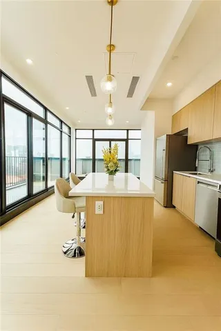 a large white kitchen with a large window