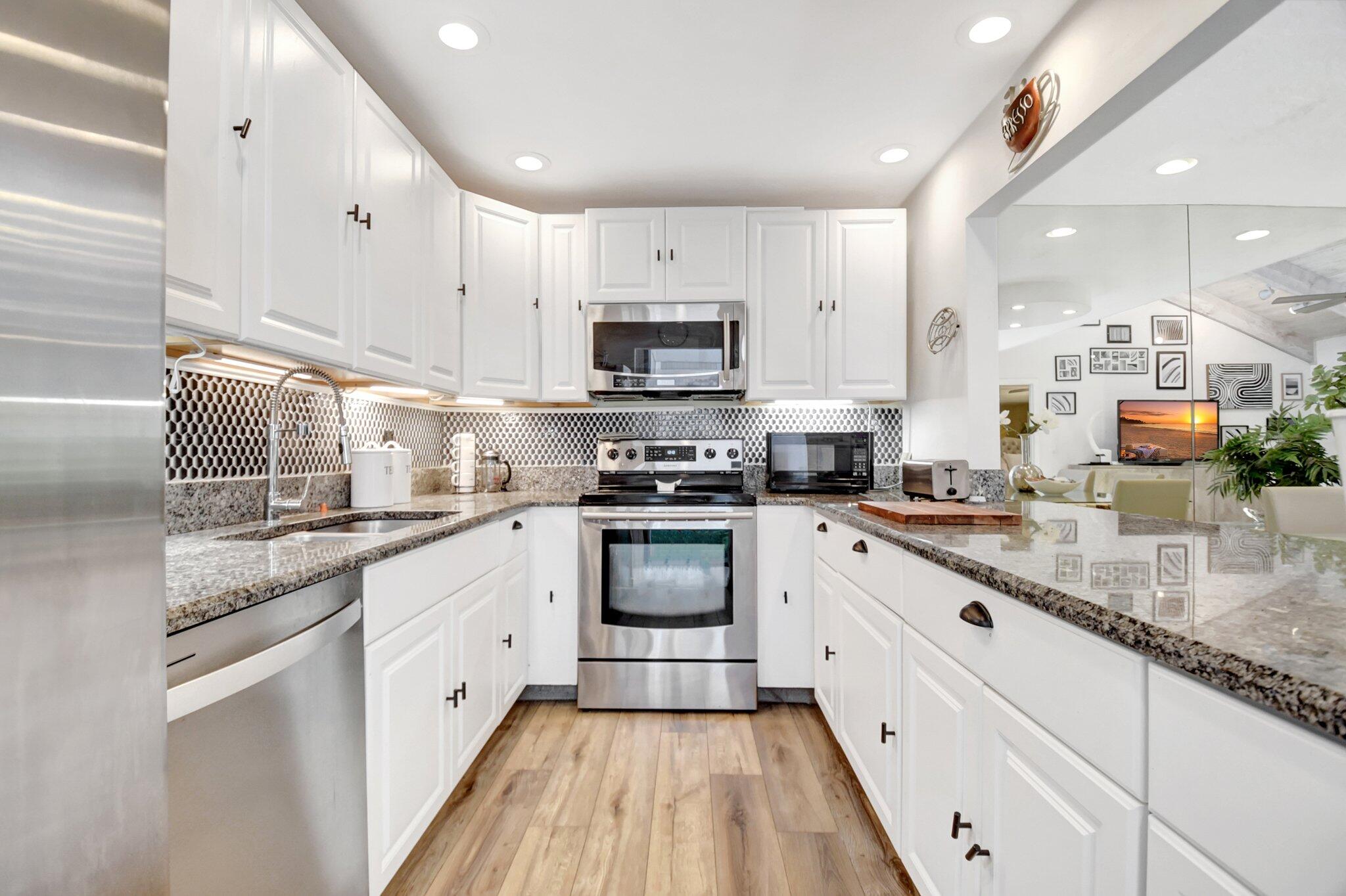 11067 Oakdale Road Boynton Beach, FL 33437 - Photo 11 of 31 a kitchen with stainless steel appliances granite countertop a stove a sink and a microwave