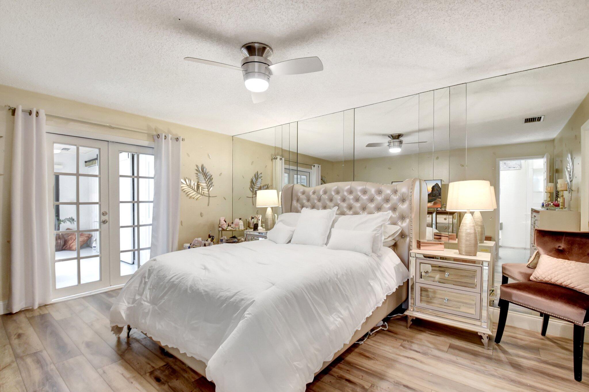 11067 Oakdale Road Boynton Beach, FL 33437 - Photo 15 of 31 a bedroom with a bed and wooden floor