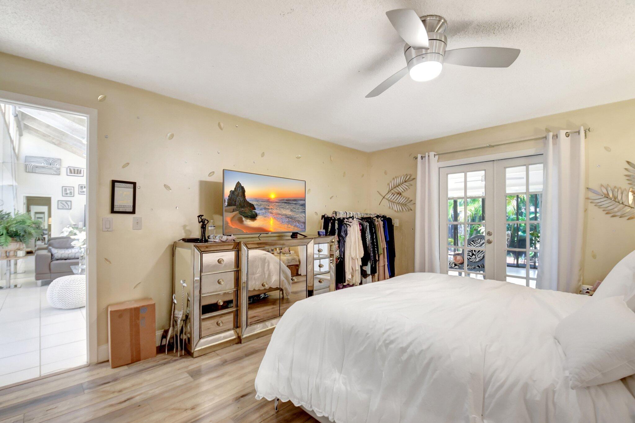 11067 Oakdale Road Boynton Beach, FL 33437 - Photo 16 of 31 a view of a bedroom with wooden floor and balcony