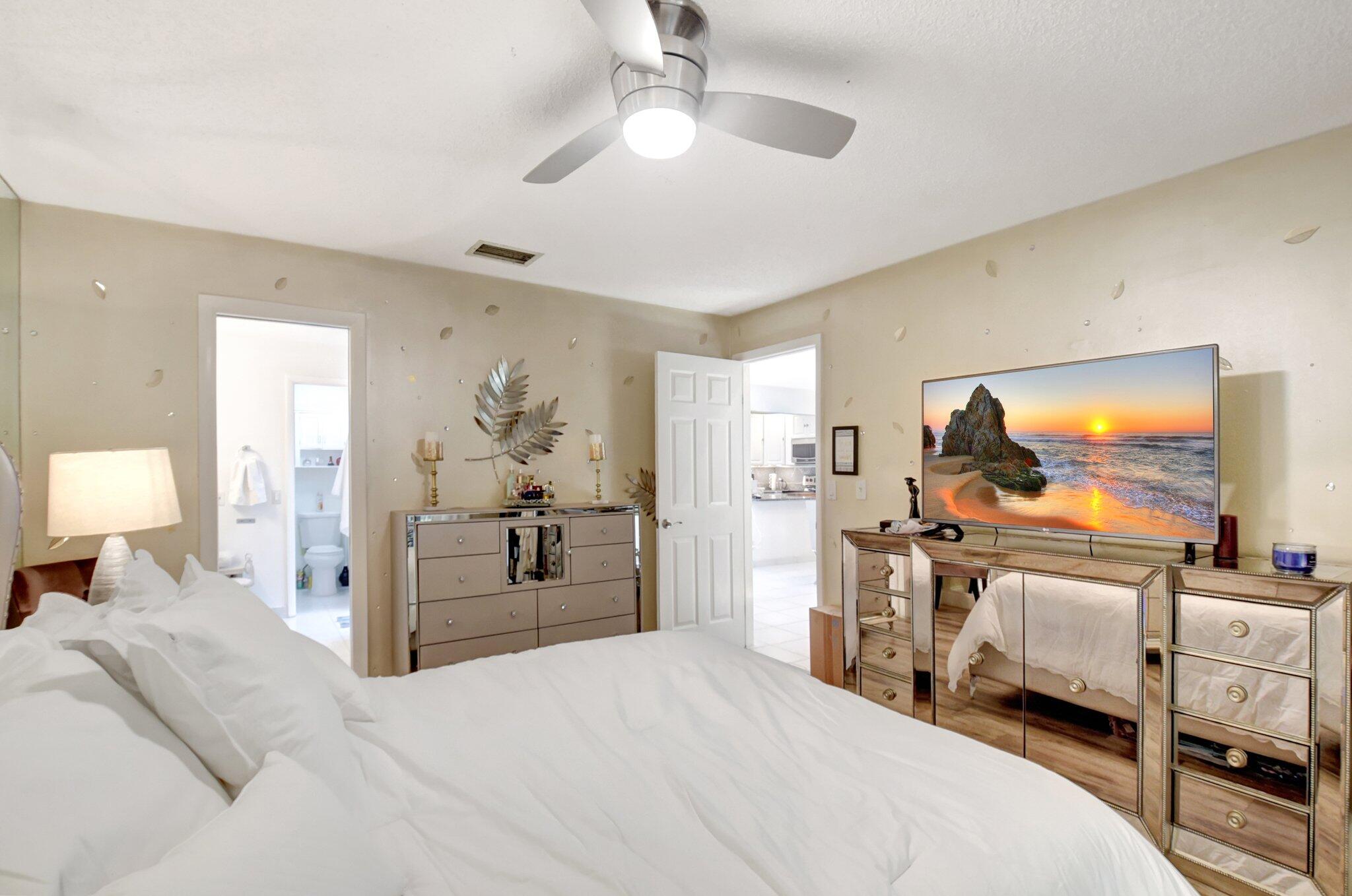 11067 Oakdale Road Boynton Beach, FL 33437 - Photo 17 of 31 a bedroom with furniture and a flat screen tv