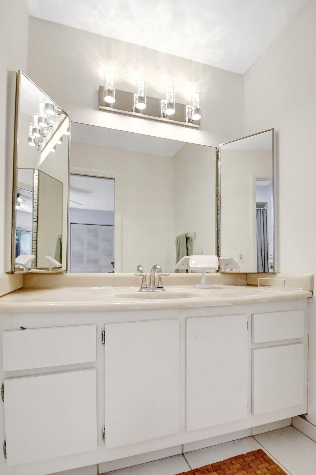 11067 Oakdale Road Boynton Beach, FL 33437 - Photo 22 of 31 a bathroom with a sink and a mirror