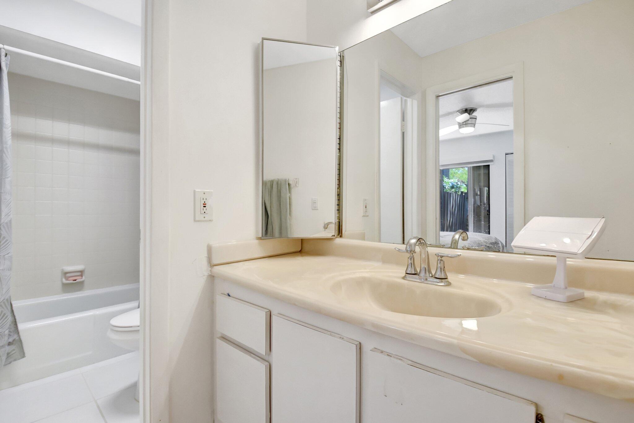 11067 Oakdale Road Boynton Beach, FL 33437 - Photo 23 of 31 a bathroom with a sink and a mirror