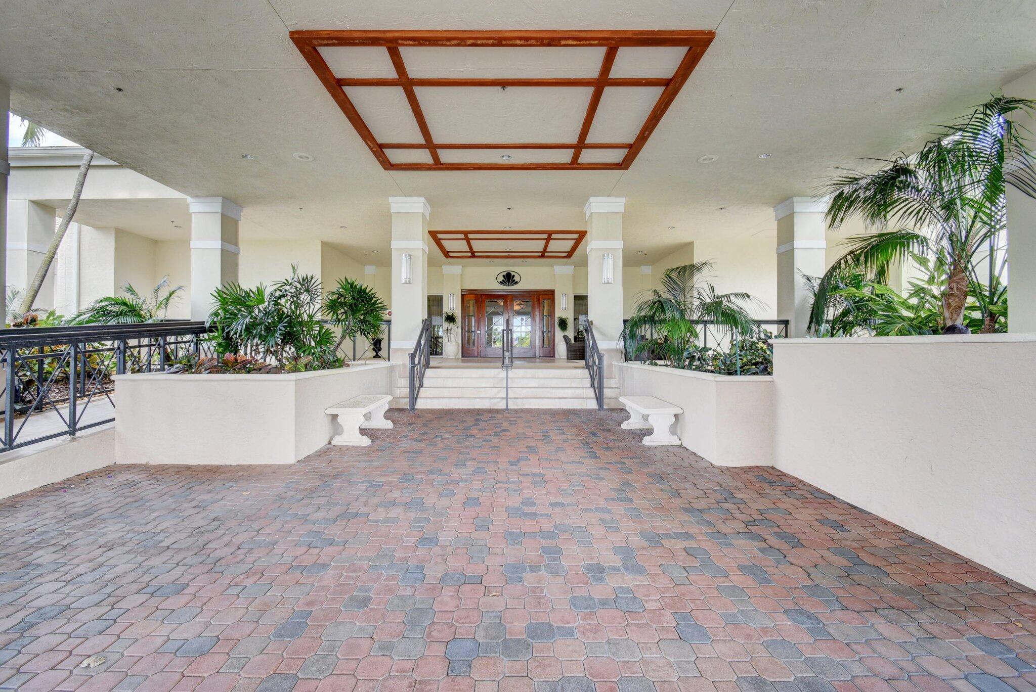 11067 Oakdale Road Boynton Beach, FL 33437 - Photo 30 of 31 a view of entryway with a flower garden