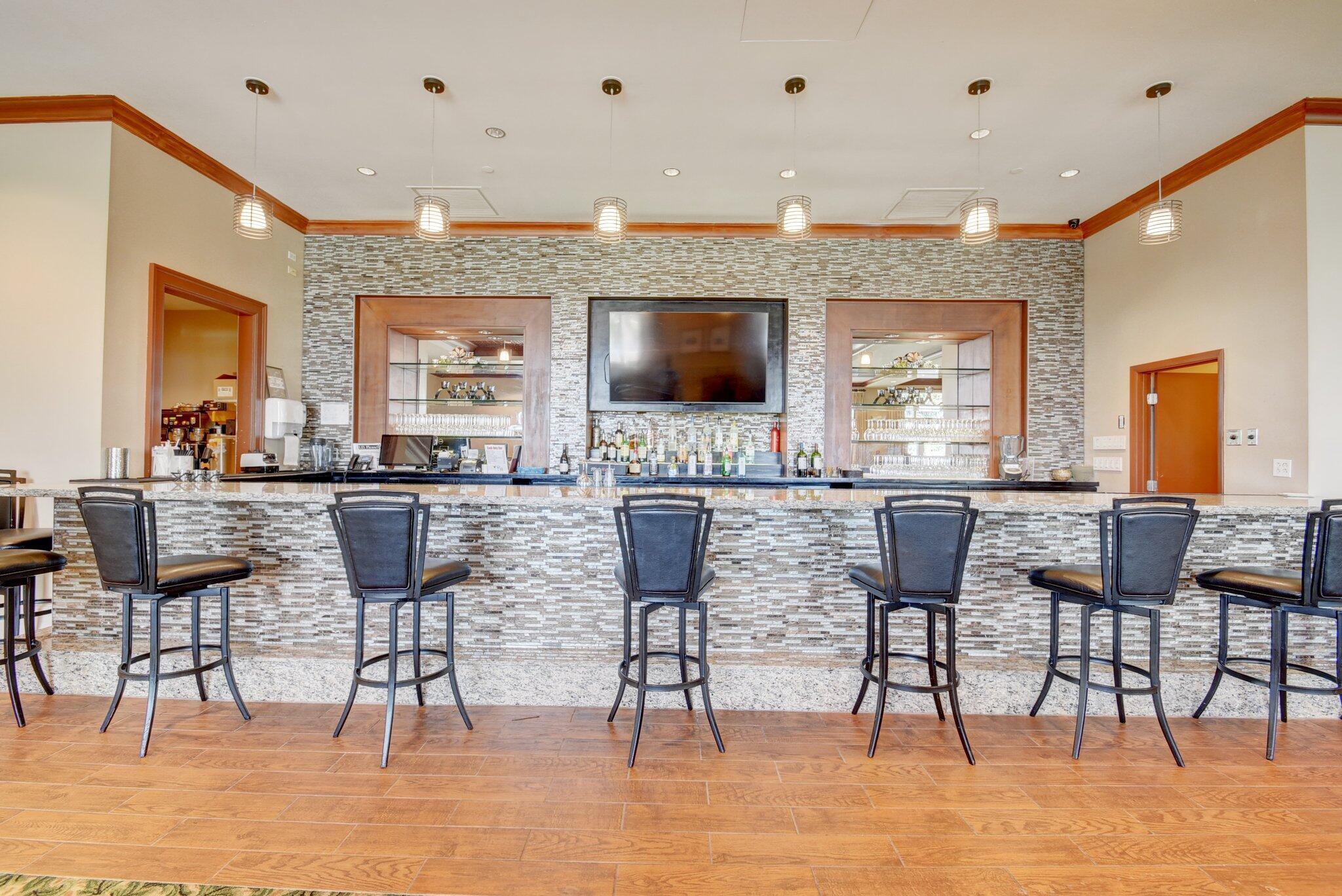 11067 Oakdale Road Boynton Beach, FL 33437 - Photo 31 of 31 a kitchen with a dining table chairs and flat screen tv