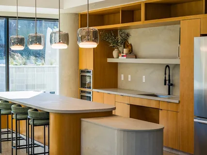 a kitchen with a sink a stove and wooden floor