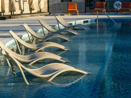 a view of house with swimming pool and outdoor seating